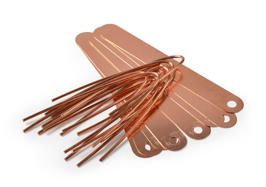 Set of copper metal tags on a white background