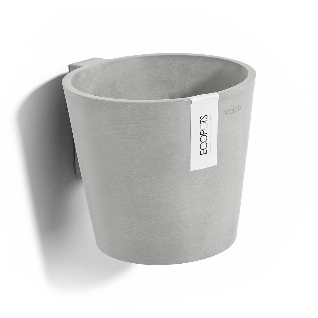 Gray recycled plastic pot on wall with label on white background