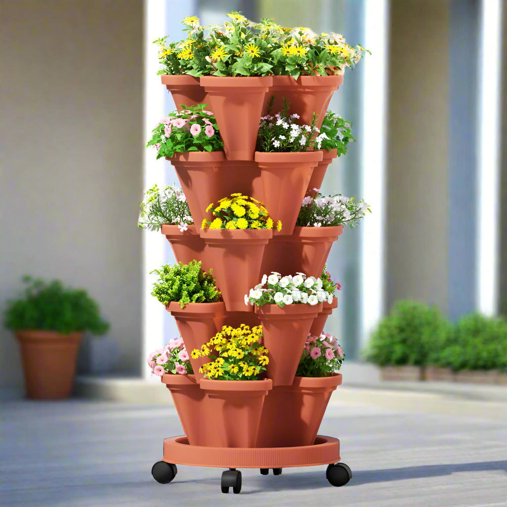 Terracotta tiered vertical planter with plants on a white background