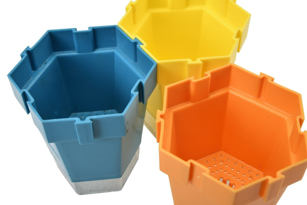 blue yellow and orange plant pots on white background