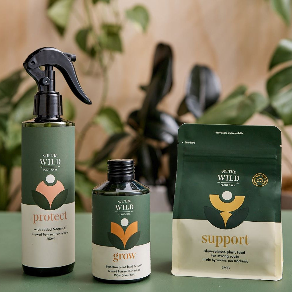 we the wild protect spray grow liquids support pellets with plants in background