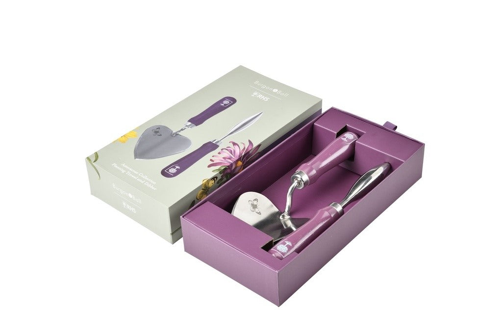 Purple gardening tool set with trowel and cultivator in a box on a white background