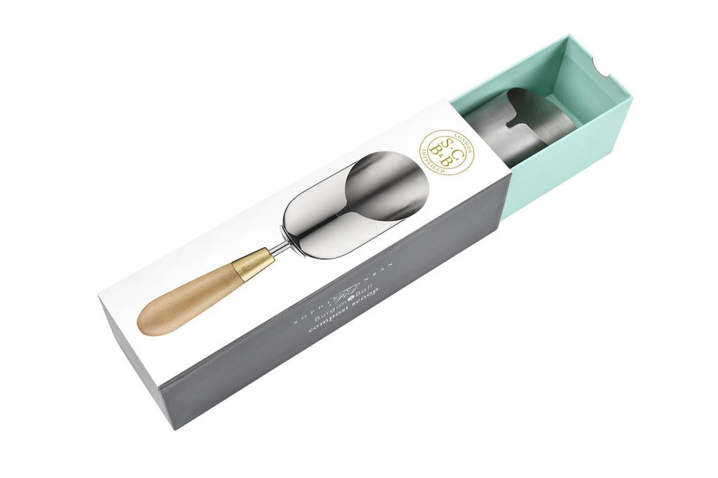Spoon with wooden handle in a gift box on a white background