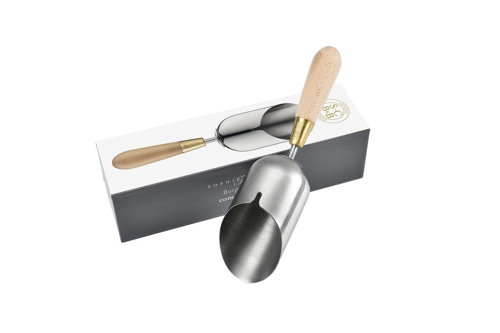 Metal trowel with wooden handle on a white background