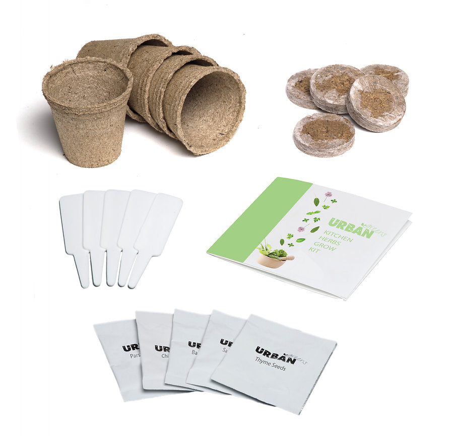 Set of biodegradable planting cups, seed starting peat pots, labels, and a seed packet on a white background.