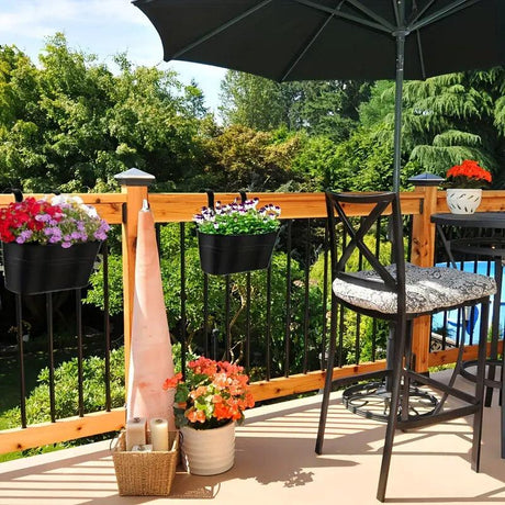 Outdoor patio with table, chairs, and hanging planters on a wooden deck.