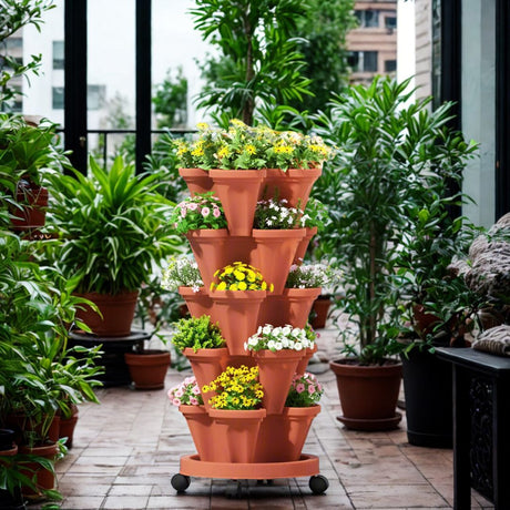 Tall terracotta plant stand with flowers in an outdoor setting