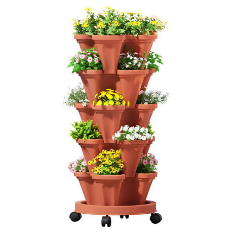 Terracotta tiered planter with plants on a white background