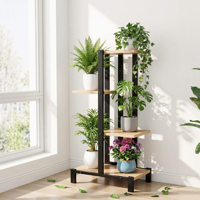 Black and wooden plant shelf with various potted plants in a bright room.
