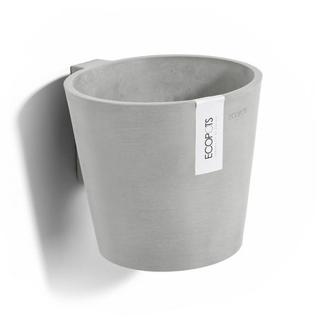 Gray recycled plastic pot on wall with label on white background