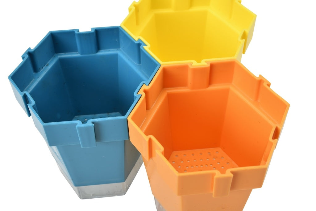 blue yellow and orange plant pots linked on white background