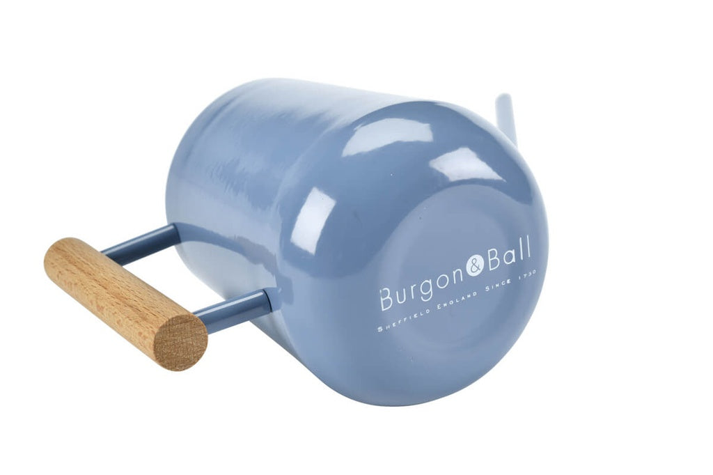 blue watering can with wooden handle