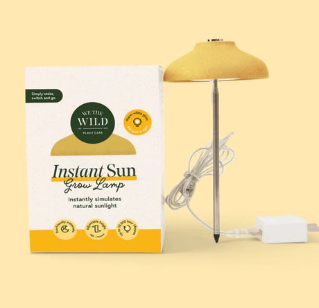 Instant Sun Grow Lamp with packaging on a yellow background