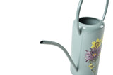 light blue watering can spout with floral design on a white background