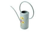 Light blue watering can with floral design on a white background