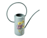 Light blue watering can with floral design on a white background