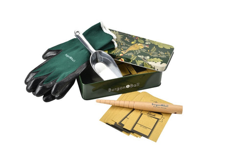 Gardening tool set with gloves, trowel, and seed packets on a white background