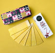 Pest traps with a colorful tin and a box on a yellow background