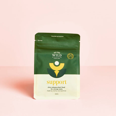 bag with we the wild support plant food for roots with pink background